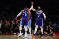 Los Angeles Lakers guard Russell Westbrook (0) high-fives forward Carmelo Anthony (7) during the first half of an NBA basketball game against the Los Angeles Clippers in Los Angeles, Friday, Dec. 3, 2021. (AP Photo/Ashley Landis)