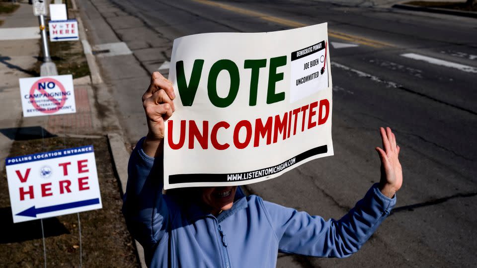 A volunteer holds a "Vote Uncommitted" sign outside of a polling station at Oakman School in Dearborn, Michigan, on February 27. - Nic Antaya/Bloomberg/Getty Images