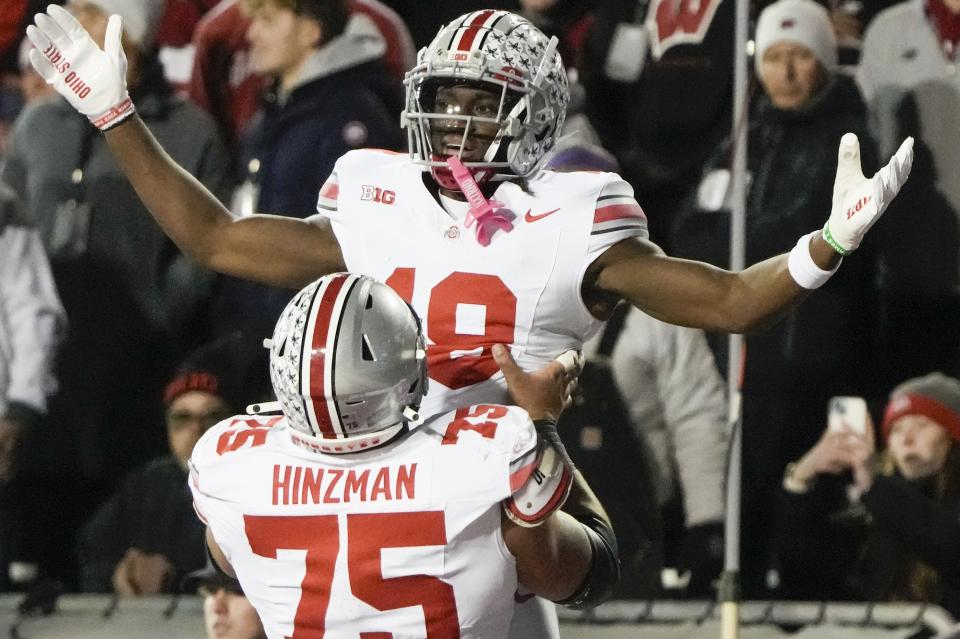 Ohio State's Marvin Harrison Jr. (18) is congratulated after his touchdown catch during the first half of an NCAA college football game against Wisconsin Saturday, Oct. 28, 2023, in Madison, Wis. (AP Photo/Morry Gash)