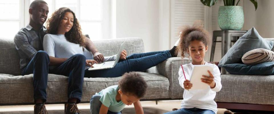 Happy black family spend free time together in living room