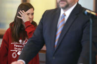 Amber Miskelly, daughter of Felicia Cox, who has been missing since July 2007, wipes tears from her face as District Attorney John Weddle, right, holds a press conference Monday, Dec. 6, 2021, in the Pontotoc County Courthouse, in Pontotoc, Miss., regarding information provided to his office by the attorneys of recently executed inmate David Neal Cox. Before his execution on Nov. 17, Cox told his attorneys he killed his sister-in-law Felicia Cox in 2007 and provided detailed instructions on where investigators could find her remains, said Weddle. (Adam Robison/The Northeast Mississippi Daily Journal via AP)