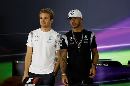 Abu Dhabi Grand Prix - Yas Marina Circuit, Abu Dhabi, United Arab Emirates - 24/11/2016 - Mercedes' Formula One drivers, Nico Rosberg of Germany (L) and Lewis Hamilton of Britain (R) pose for photo call as they arrive at Press Room for a news conference. REUTERS/Hamad I Mohammed