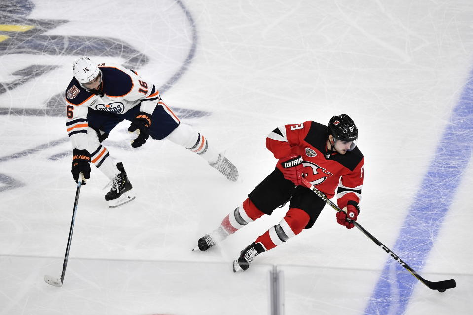 Edmonton Oilers Jujhar Khaira, left and New Jersey Devils Will Butcher vie for the puck, during the season-opening NHL Global Series hockey match between Edmonton Oilers and New Jersey Devils at Scandinavium in Gothenburg, Sweden, Saturday, Oct. 6, 2018, (Bjorn Larsson Rosvall /TT News Agency via AP)