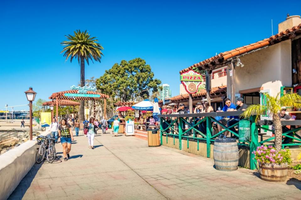 People enjoy the Seaport Village district in San Diego via Getty Images