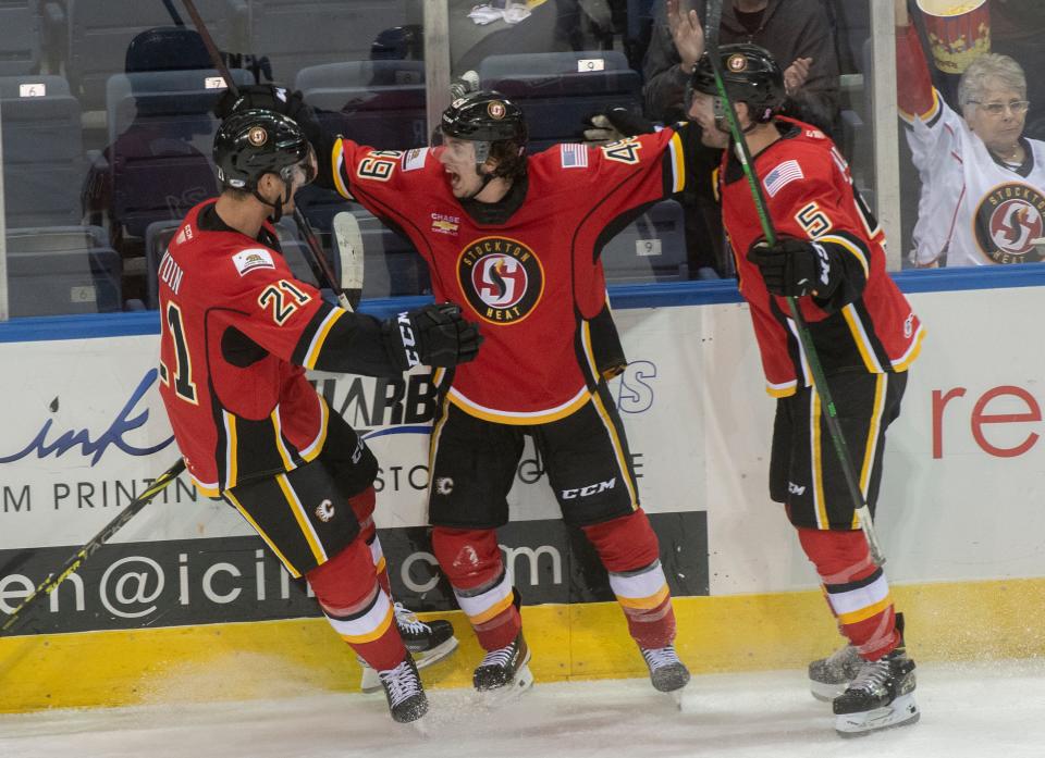 Stockton Heat's Jakob Pelletier, center, celebrates scoring a goal with teammates Glenn Gawdin, left, and Colton Poolman during the first round of the Calder Cup playoffs against the Bakersfield Condors Tuesday at Stockton Arena.