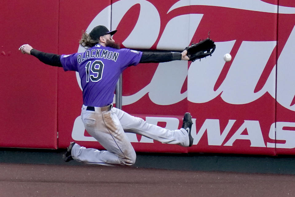 Colorado Rockies right fielder Charlie Blackmon is unable to catch a ground-rule double by St. Louis Cardinals' Nolan Arenado during the second inning of a baseball game Friday, May 7, 2021, in St. Louis. (AP Photo/Jeff Roberson)