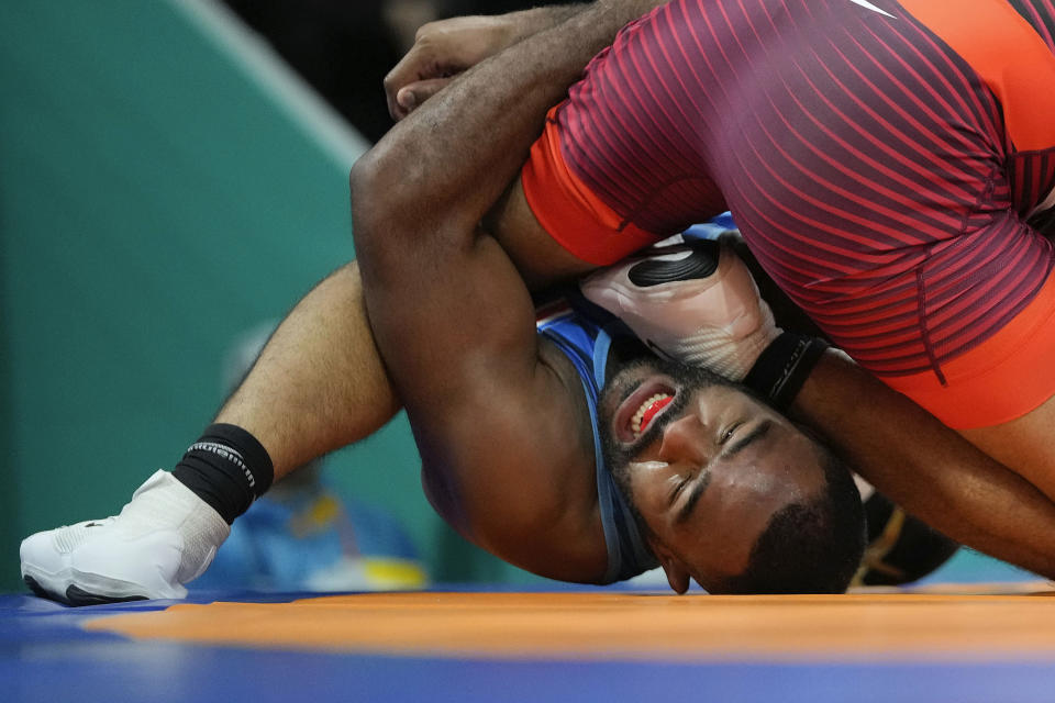 Costa Rica's Maxwell Lacey, left, competes with Canada's Nishan Randhawa during the men's 97kg wrestling freestyle bronze medal match at the Pan American Games Santiago, Chile, Wednesday, Nov. 1, 2023. (AP Photo/Matias Delacroix)