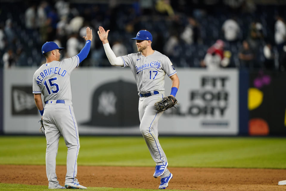 Kansas City Royals second baseman Whit Merrifield (15) and left fielder Hunter Dozier (17) celebrate after the Royals defeated the New York Yankees 6-5 in a baseball game, Tuesday, June 22, 2021, at Yankee Stadium in New York. (AP Photo/Kathy Willens)