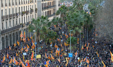 FILE PHOTO: People fly "Esteladas" (Catalan separatist flag) during a demonstration held by pro-independence associations in Barcelona, Spain March 11, 2018. REUTERS/Albert Gea