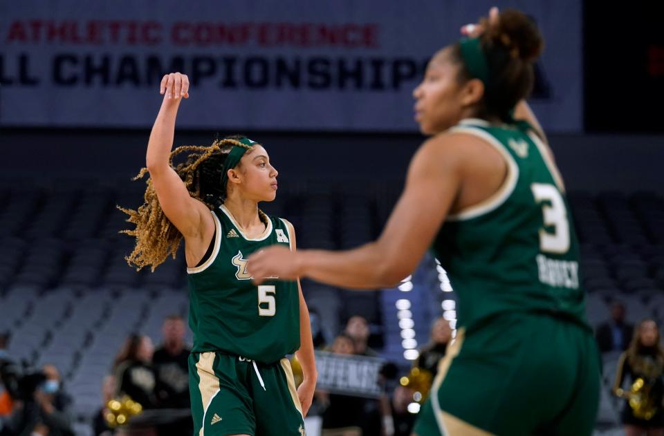 South Florida's Elena Tsineke (5) and Sydni Harvey (3) celebrate after Tsineke sank a 3-point basket against Central Florida during the second half of an NCAA college basketball game for the American Athletic Conference women's tournament championship Thursday, March 10, 2022, in Fort Worth, Texas. (AP Photo/Tony Gutierrez)