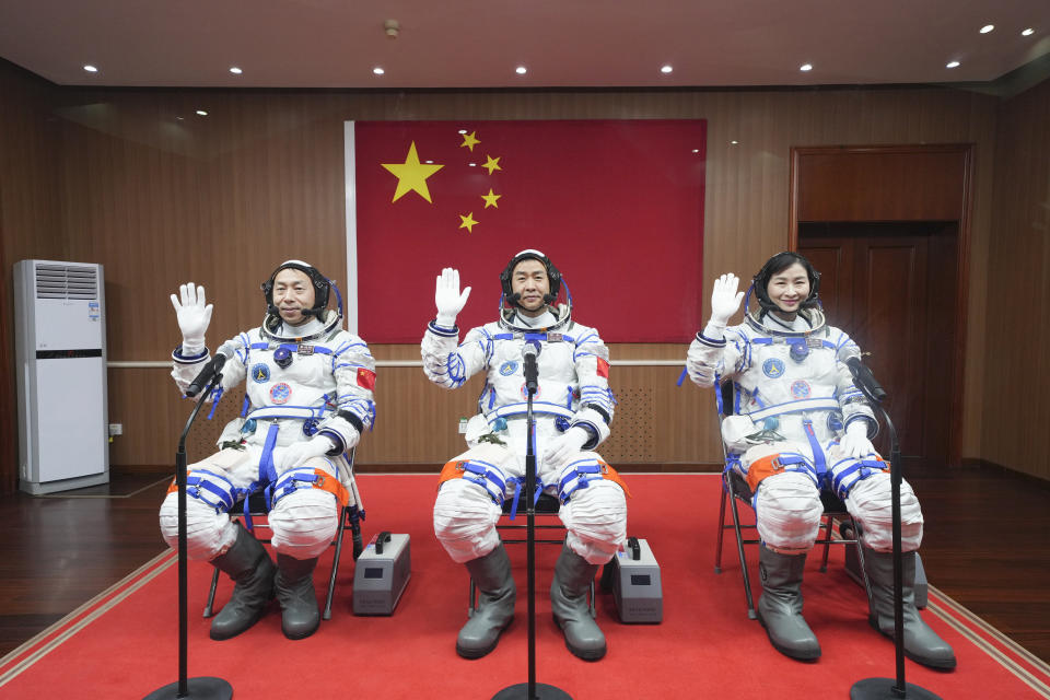 In this photo released by Xinhua News Agency, from left Chinese astronauts Cai Xuzhe, Chen Dong and Liu Yang wave before a sendoff ceremony for the Shenzhou-14 crewed space mission at the Jiuquan Satellite Launch Center in northwestern China on Sunday, June 5, 2022. China on Sunday launched a new three-person mission to complete work on its permanent orbiting space station. (Li Gang/Xinhua via AP)