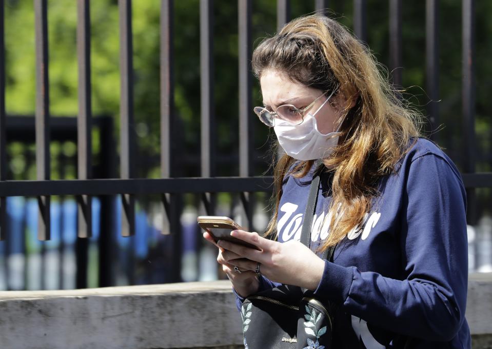 A Lebanese woman wears a surgical mask as protection from the novel coronavirus outbreak, while she checks her phone in the capital Beirut, on March 2, 2020. - Lebanon announced on February 28, it would bar entry to non-resident foreigners from the four countries most affected by the COVID-19 epidemic, a day after announcing its third case. (Photo by JOSEPH EID / AFP) (Photo by JOSEPH EID/AFP via Getty Images)