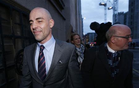 Daniel Evans (L), former journalist at News of The World and Sunday Mirror, leaves the Old Bailey courthouse after giving evidence in London January 27, 2014. REUTERS/Suzanne Plunkett