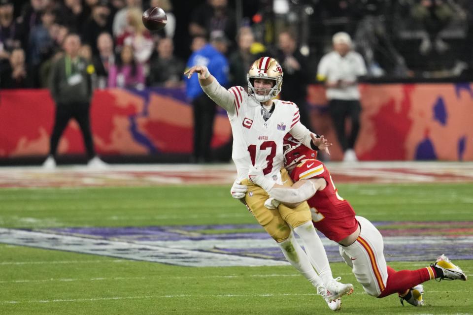 San Francisco 49ers quarterback Brock Purdy (13) throws under pressure from Kansas City Chiefs linebacker Leo Chenal (54) during the second half of the NFL Super Bowl 58 football game Sunday, Feb. 11, 2024, in Las Vegas. (AP Photo/Abbie Parr)