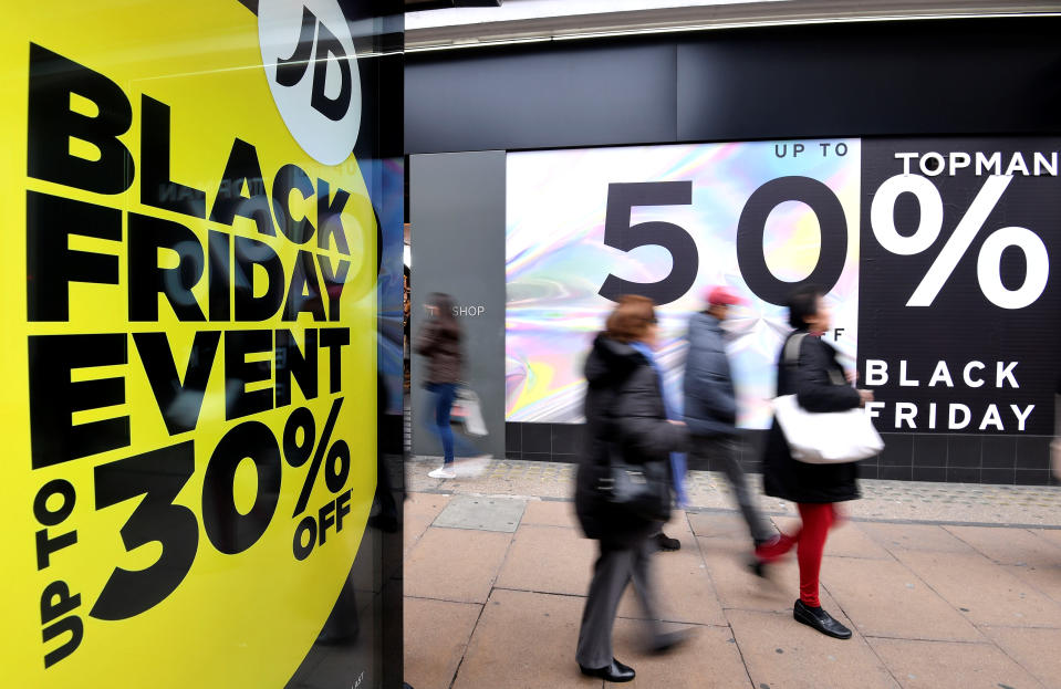Shoppers walk past Black Friday signage on Oxford Street in London, Britain, November 23, 2018. REUTERS/Toby Melville