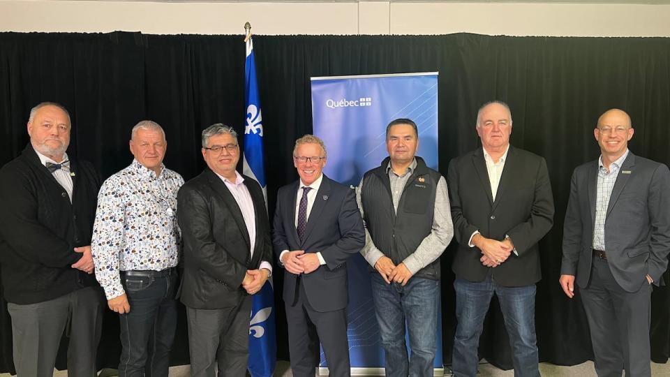 A group of officials at a press conference Tuesday in Lebel-sur-Quévillon, including Alfred Loon, 3rd left, President of Eeyou Communications Network,  Jean Boulet, 4th left,  Quebec minister of labour and minister responsible for northern Que., Norman A. Wapachee, 3rd right, Deputy Cree Grand Chief and Denis Lamothe, 2nd right, deputy for Ungava riding.