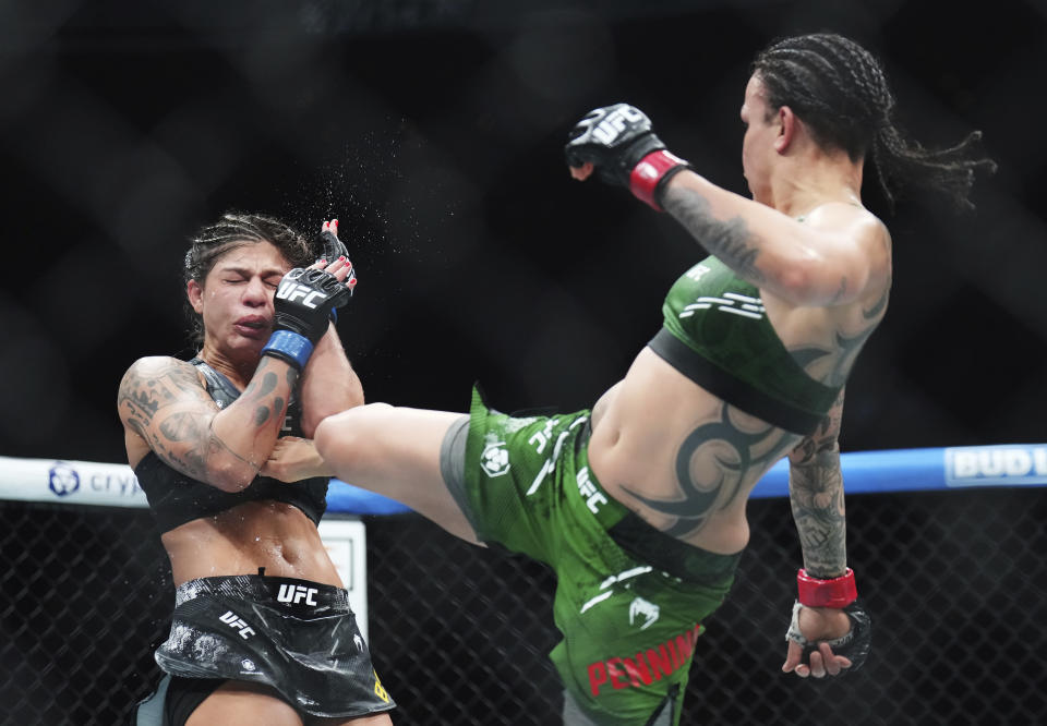 Raquel Pennington, right, kicks Mayra Bueno Silva during a women's bantamweight title bout during the UFC 297 mixed martial arts event in Toronto on Saturday, Jan. 20, 2024. (Nathan Denette/The Canadian Press via AP)