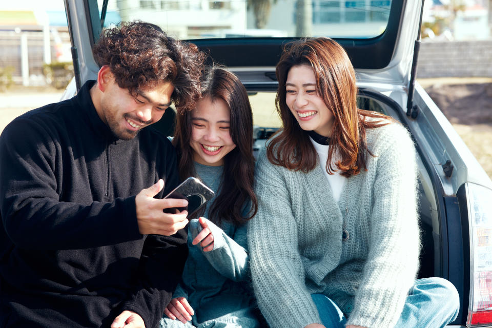 Three people, one man and two women, are enjoying it.