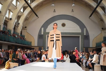 Models present creations during the Molly Goddard catwalk show during London Fashion Week in London