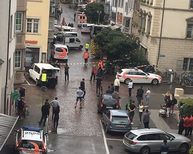 Police gather in the Swiss town after a man went on a chainsaw rampage. Source: Twitter