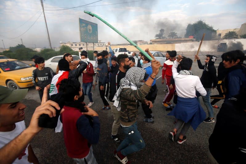 Protesters shout slogans during ongoing anti-government protests in Basra