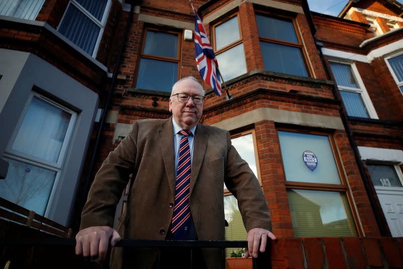 Unionist Orange order leader Gibson poses for a photograph outside his house in Belfast