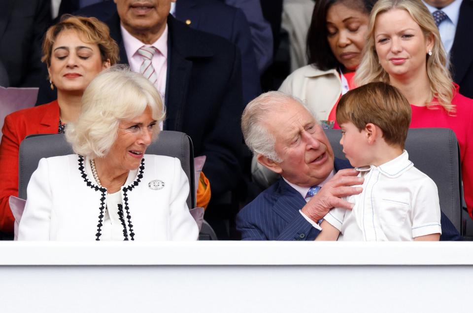 Camilla, Duchess of Cornwall looks on as Prince Louis of Cambridge sits on his grandfather Prince Charles, Prince of Wales's lap as they attend the Platinum Pageant on The Mall on June 5, 2022 in London, England. The Platinum Jubilee of Elizabeth II is being celebrated from June 2 to June 5, 2022, in the UK and Commonwealth to mark the 70th anniversary of the accession of Queen Elizabeth II on 6 February 1952.