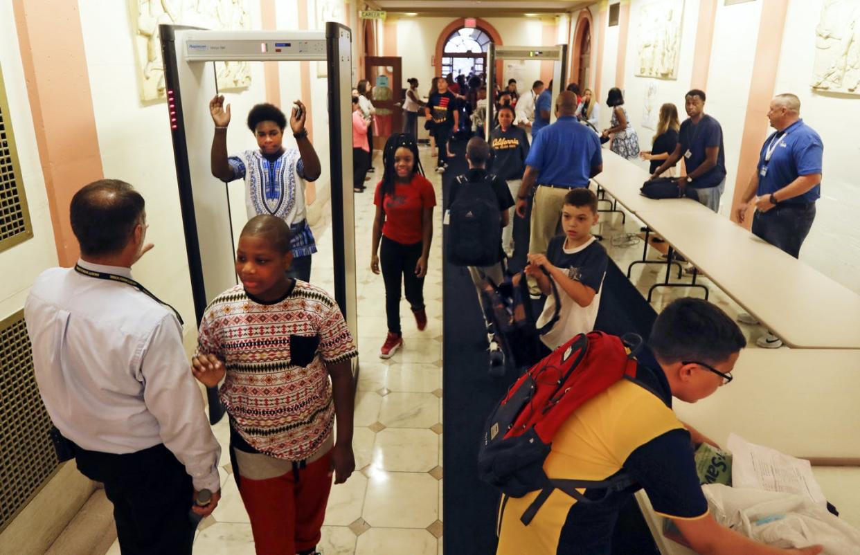 <span class="caption">In this photo from 2016, students pass through a security checkpoint at William Hackett Middle School in Albany, N.Y., with guards, bag inspections and a metal detector. </span> <span class="attribution"><a class="link " href="https://newsroom.ap.org/detail/SchoolsThreatAssessment/00c4332ea60243ea9f7cce08c2bec246/photo" rel="nofollow noopener" target="_blank" data-ylk="slk:AP Photo/Mike Groll;elm:context_link;itc:0;sec:content-canvas">AP Photo/Mike Groll</a></span>