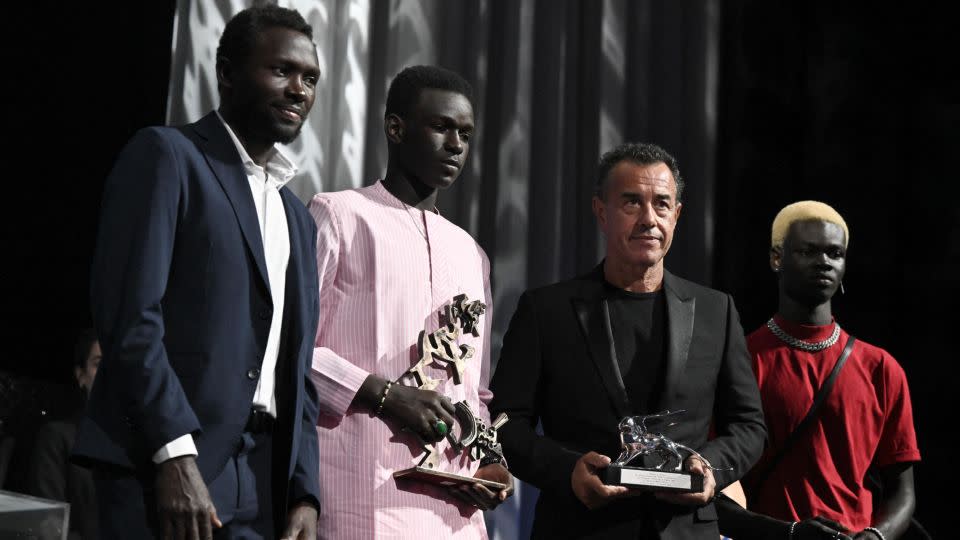Left to right: Script consultant Mamadou Kouassi, actor Seydou Sarr, director Matteo Garrone and actor Moustapha Fall, as Garrone received the Silver Lion for Best Director for "Io Capitano" at the Venice Film Festival on September 9, 2023. - TIZIANA FABI/AFP via Getty Images