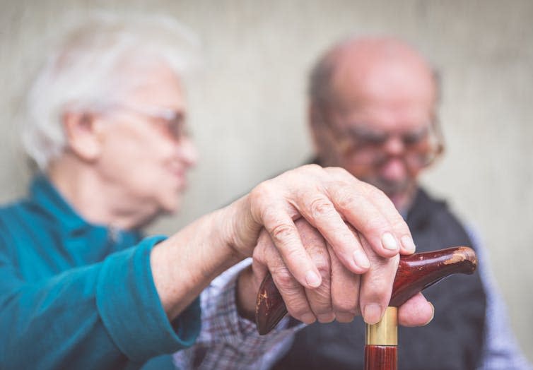 A blurry photo of an elderly couple.