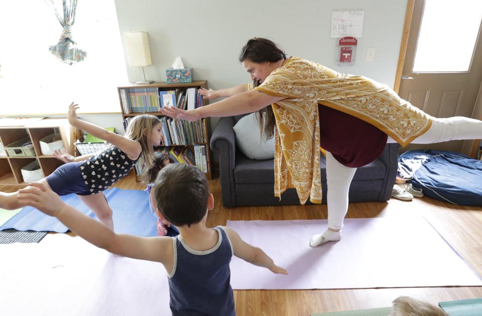 Lead teacher Caren Jorgensen teaches a yoga class at Fox Valley Montessori Academy Monday, May 22, 2023, in Appleton, Wis.