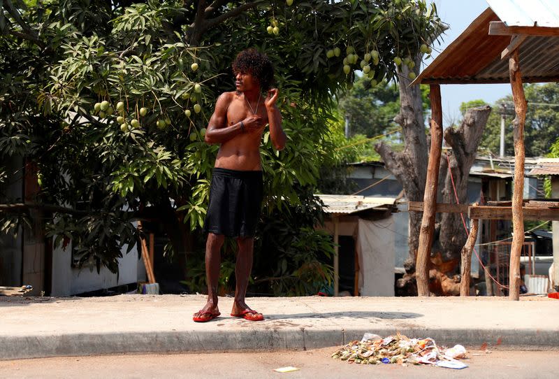 FILE PHOTO: A resident waits for a bus as he stands on a footpath in the area called Poreporena Villages in the city of Port Moresby in Papua New Guinea