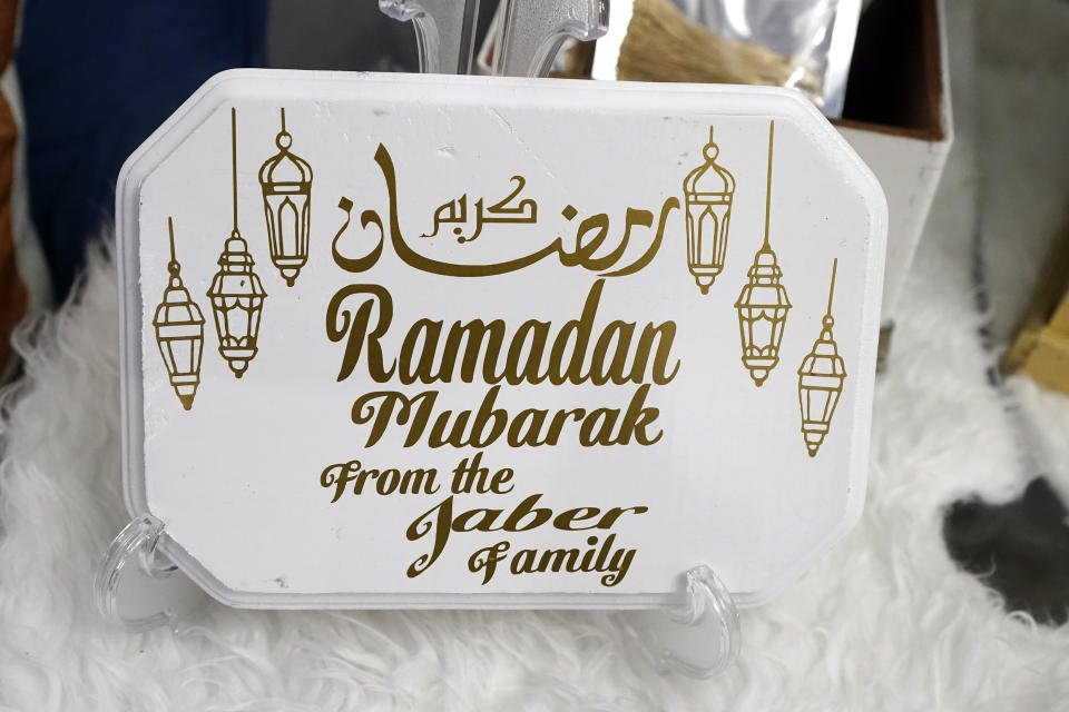 A Ramadan sign created by Suzanne Jaber of The Eid Shop is displayed in Dearborn Heights, Mich., on Monday, March 27, 2023. More businesses are selling Ramadan and Eid items, including DIY kits, lanterns and napkin holders. She began crafting and selling her own dedicated Ramadan and Eid decorations and now ships items across the U.S. and world. (AP Photo/Carlos Osorio)