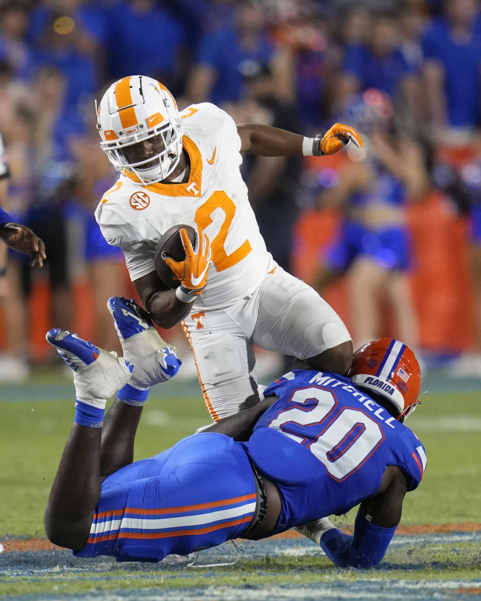 Tennessee running back Jabari Small (2) is stopped by Florida linebacker Teradja Mitchell (20) during the second half of an NCAA college football game, Saturday, Sept. 16, 2023, in Gainesville, Fla. (AP Photo/John Raoux)