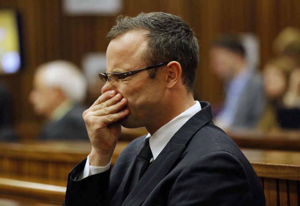 Olympic and Paralympic track star Oscar Pistorius sits in the dock at the North Gauteng High Court in Pretoria March 11, 2014. Pistorius is on trial for the murder of his girlfriend Reeva Steenkamp at his suburban Pretoria home on Valentine's Day last year. REUTERS/Kim Ludbrook/Pool (SOUTH AFRICA - Tags: SPORT CRIME LAW)