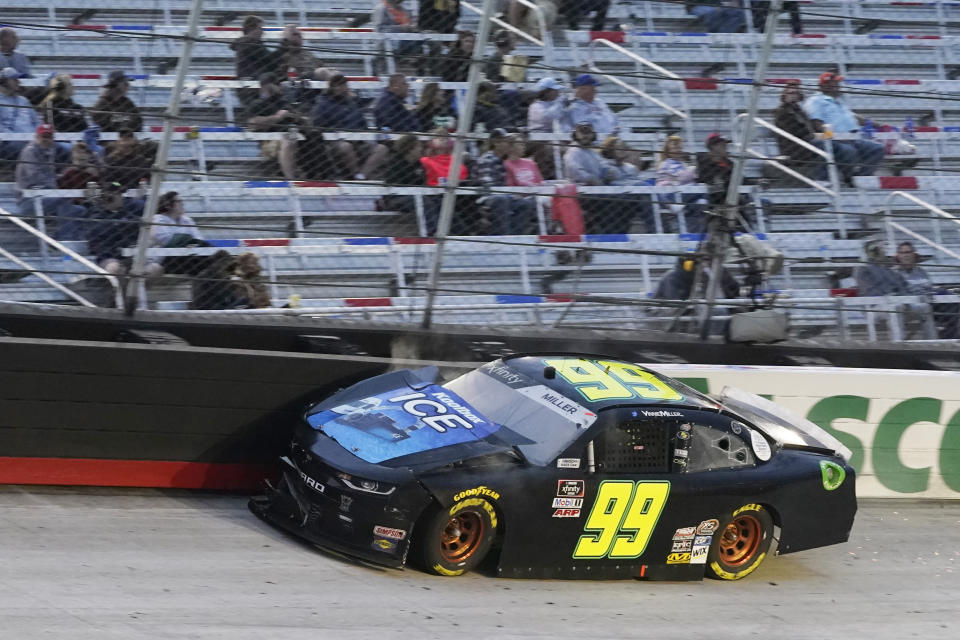 Vinnie Miller (99) scrubs the wall in Turn 1 during the NASCAR Xfinity Series auto race Friday, Sept. 18, 2020, in Bristol, Tenn. (AP Photo/Steve Helber)