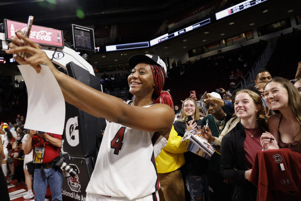 South Carolina forward Aliyah Boston takes a selfie photo for fans after South Carolina defeated Georgia 73-63 in an NCAA college basketball game in Columbia, S.C., Sunday, Feb. 26, 2023. (AP Photo/Nell Redmond)