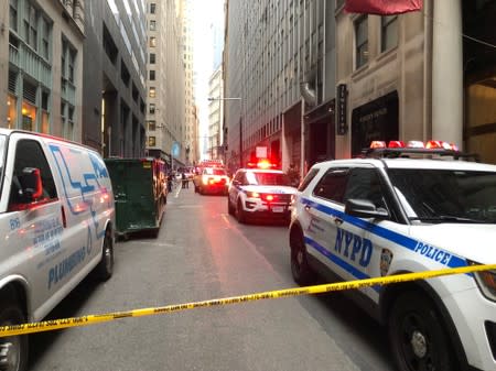 NYPD vehicles are seen in a restricted area after an incident at the Fulton St. subway station in Manhattan, New York