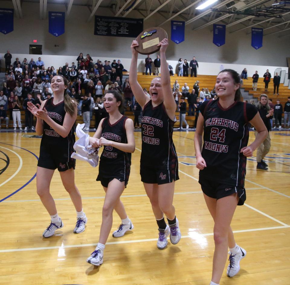 Albertus Magnus', from left, Kate O'Leary, Sophia Malpeli, Allie Falesto and Kaleigh McGuinness celebrate winning the New York State Class AA regional girls basketball final versus Wallkill on March 8, 2024.