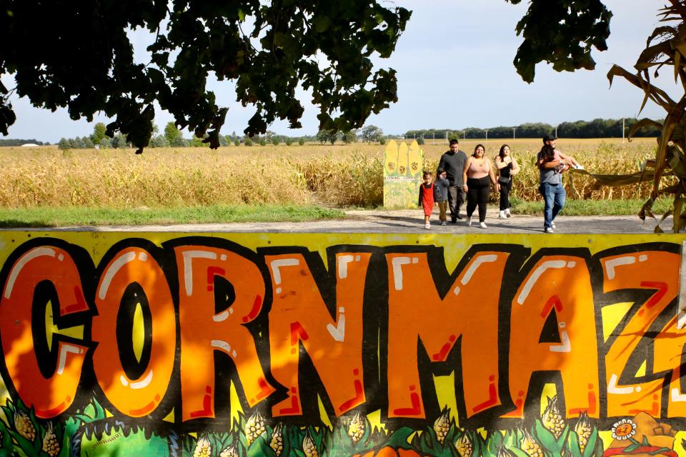 A family walks out of a corn maze Sunday, Sept. 24, 2023, at Lindberg Pumpkin Patch in Caledonia.