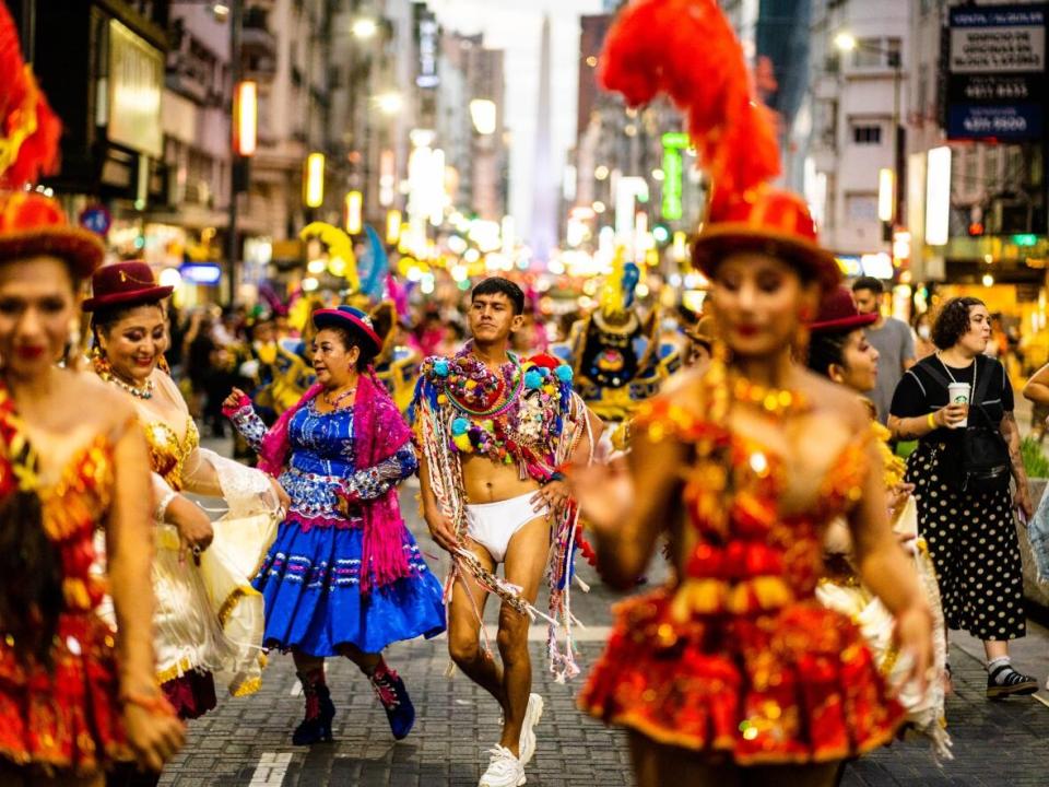 Tiziano Cruz, centre, is surrounded by dancers and other artists in Buenos Aires recently. In Montreal, he will lead a parade from Place Émilie-Gamelin to the National Theatre on Sunday at 5 p.m. and again on Monday and Tuesday at 7 p.m.  (Diego Astarita/AFS - image credit)