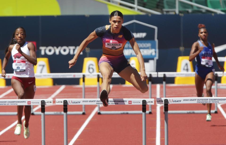 Sydney McLaughlin, center, clears the last hurdle on her way to a world record in the women's 400 meter hurdles on day three of the USA Track and Field Championships 2022 at Hayward Field in Eugene Saturday June 25, 2022.