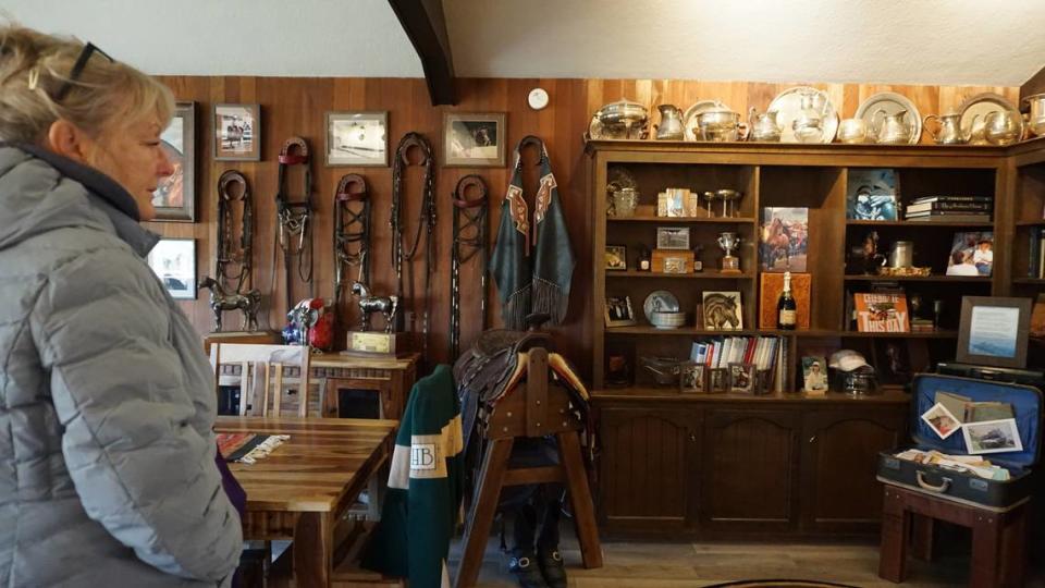 Varian Arabians ranch manager Angela Alvarez looks at some of Sheila Varian’s possessions in the Sheila Varian Museum.