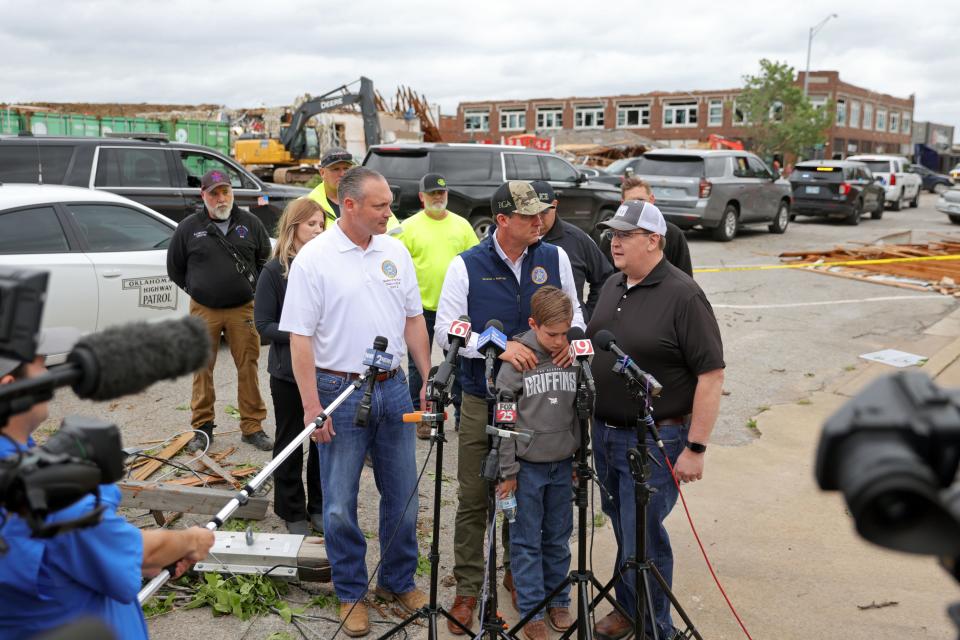 Gov. Kevin Stitt speaks during a press conference surrounded by his son Houston, House Speaker Charles McCall, left, and Senate majority floor leader Greg McCortney in Sulphur, Okla., Sunday, April 28, 2024. The town of Sulphur was hit by a tornado the night before killing one person.