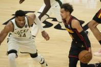 Atlanta Hawks' Trae Young tries to drive on Milwaukee Bucks' Giannis Antetokounmpo during the first half of Game 2 of the NBA Eastern Conference basketball finals game Friday, June 25, 2021, in Milwaukee. (AP Photo/Morry Gash)