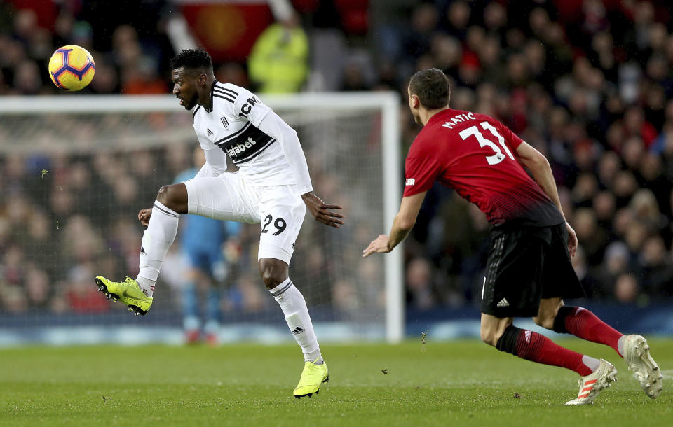 Fulham's Andre-Frank Zambo Anguissa, left, and Manchester United's Nemanja Matic in action during their English Premier League soccer match at Old Trafford, Manchester, England, Saturday, Dec. 8, 2018. (Barrington Coombs/PA via AP)