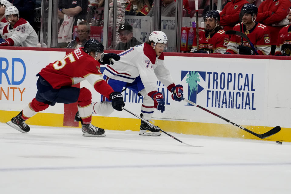 Florida Panthers center Anton Lundell (15) and Montreal Canadiens center Jake Evans chase the puck during the first period of an NHL hockey game Thursday, Feb. 29, 2024, in Sunrise, Fla. (AP Photo/Lynne Sladky)