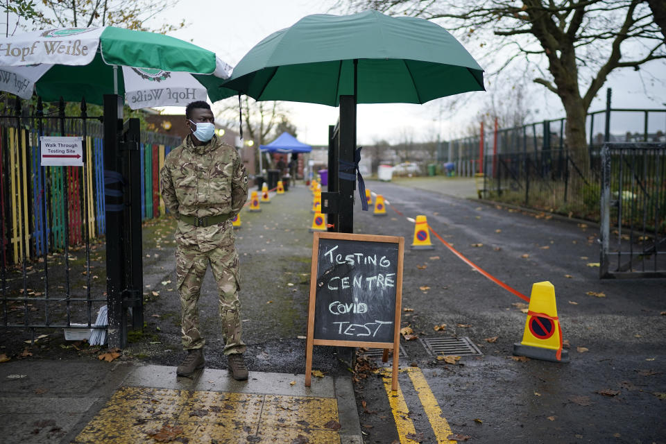 LIVERPOOL, ENGLAND - NOVEMBER 11: A soldier from the 1st battalion Coldstream Guards greets members of the public at a coronavirus testing centre set up at the Merseyside Caribbean Council Community Centre on November 11, 2020 in Liverpool, England. More than 23,000 people had been tested for covid-19 in the first three days of the city's mass testing trial. In that time, 154 people tested positive. All residents and workers in the city were offered the test. (Photo by Christopher Furlong/Getty Images)