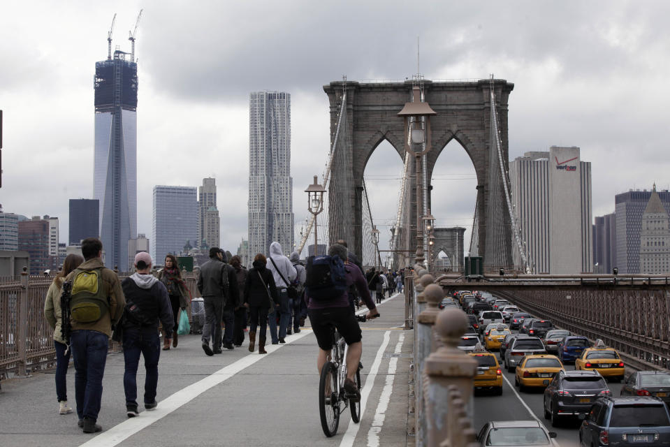 Commuters cross New York's Brooklyn Bridge, Wednesday, Oct. 31, 2012. The floodwaters that poured into New York's deepest subway tunnels may pose the biggest obstacle to the city's recovery from the worst natural disaster in the transit system's 108-year history. (AP Photo/Richard Drew)