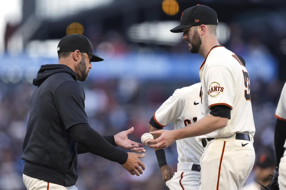 San Francisco Giants starting pitcher Alex Wood, right, is taken out of the baseball game by manager Gabe Kapler, left, during the fourth inning against the Los Angeles Angels on Tuesday, June 1, 2021, in San Francisco. (AP Photo/Tony Avelar)
